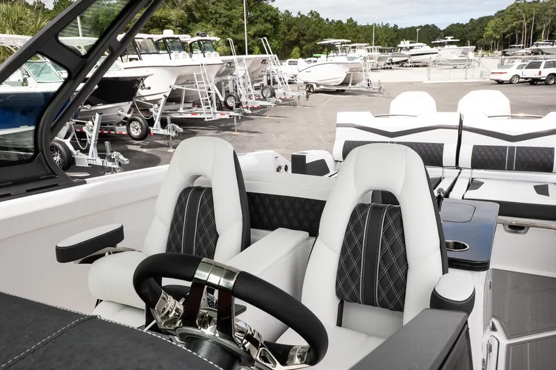 Slide: The Image of Interior of 2026 Monterey Elite 30 OB boat with luxurious seating and steering wheel. - 25