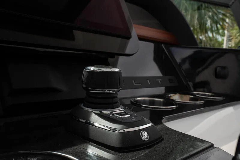 Slide: The Image of 2026 Monterey Elite 30 OB boat control panel with joystick and cup holders. - 26