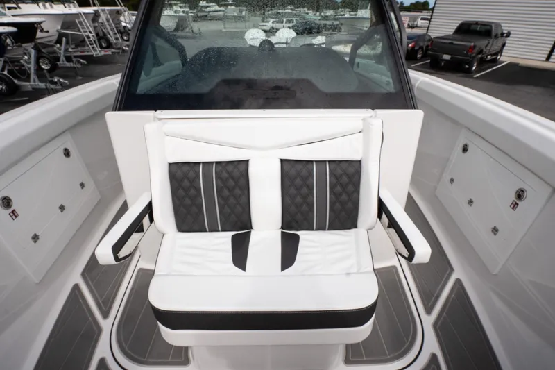 Slide: The Image of 2026 Monterey Elite 30 OB boat interior with cushioned seating and sleek design. - 29