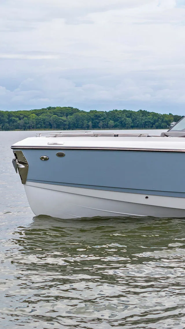 Slide: The Image of 2026 Monterey Elite 30 OB boat interior with seating and helm, showcasing modern design. - 31