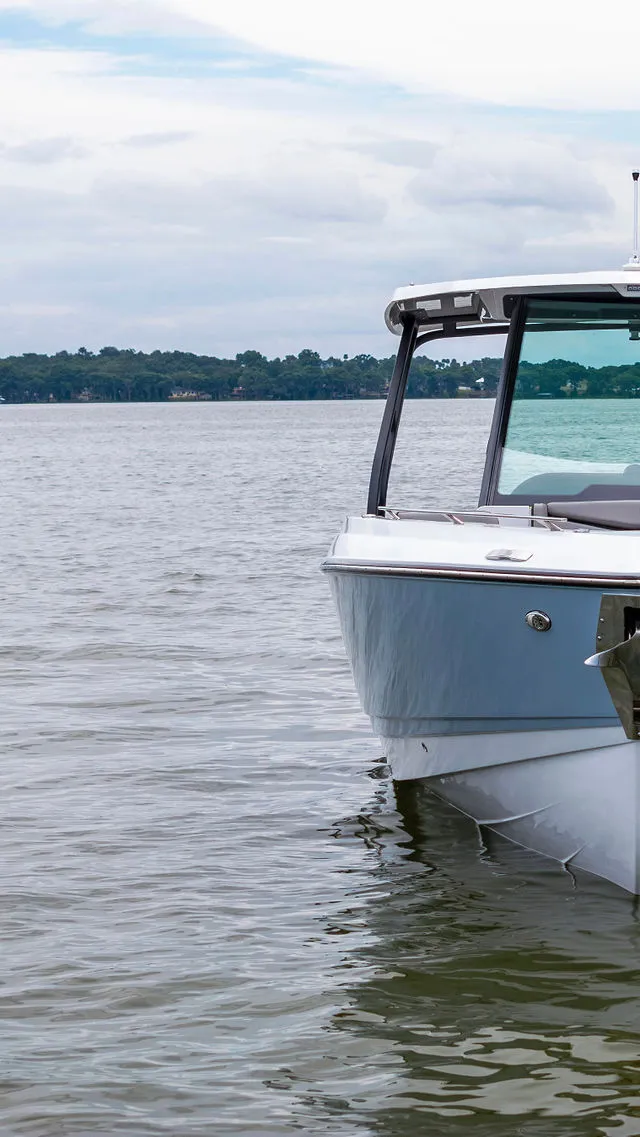 Slide: The Image of 2026 Monterey Elite 30 OB boat interior with sleek seating and modern dashboard design. - 32