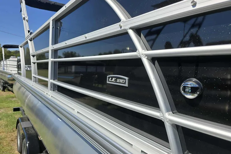 Slide: The Image of 2026 Trifecta 22RFLE275 pontoon boat with sleek aluminum railing design. - 10