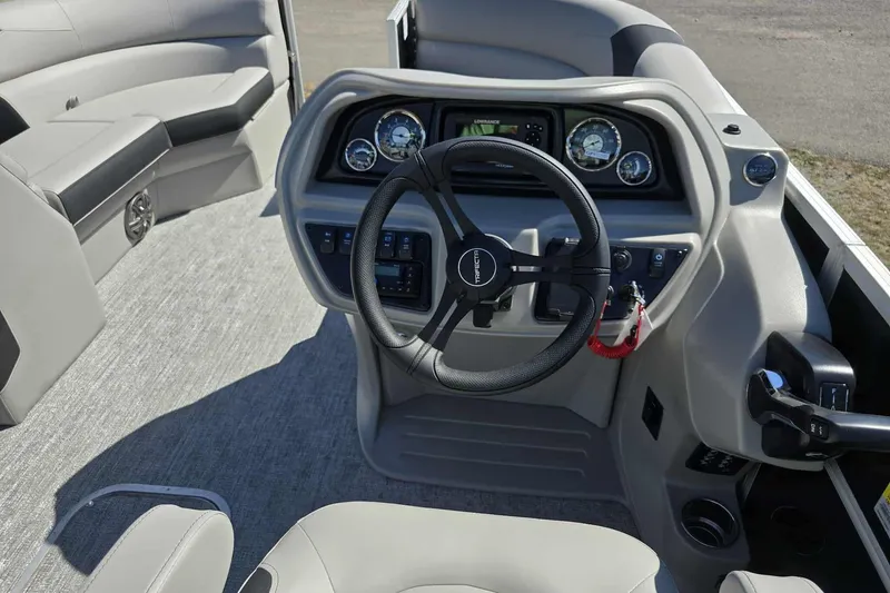 Slide: The Image of Cockpit of 2026 Trifecta 22RFLE275 pontoon boat with modern steering and controls. - 7