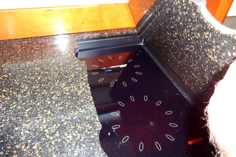 Slide: The Image of Corian countertop with integrated black cooktop on a 2007 Meridian 459. - 106