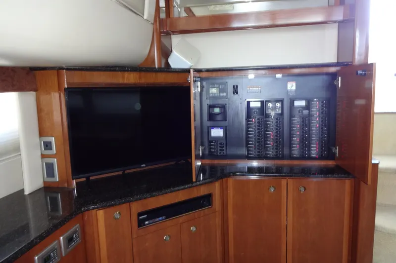Slide: The Image of 2007 Meridian 459 yacht interior with control panel and TV setup. - 112