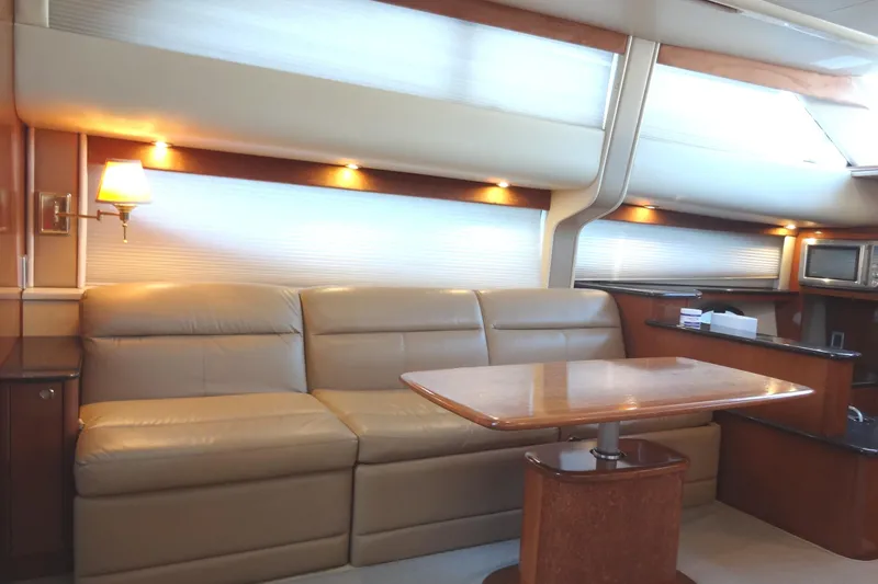 Slide: The Image of Luxurious interior of 2007 Meridian 459 yacht with leather seating and wooden table. - 114