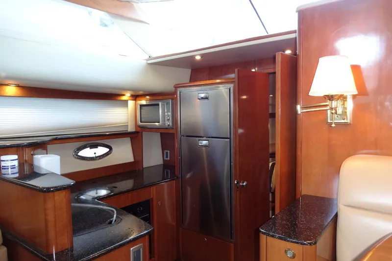 Slide: The Image of Luxurious 2007 Meridian 459 yacht interior with modern kitchen and elegant wood finishes. - 119