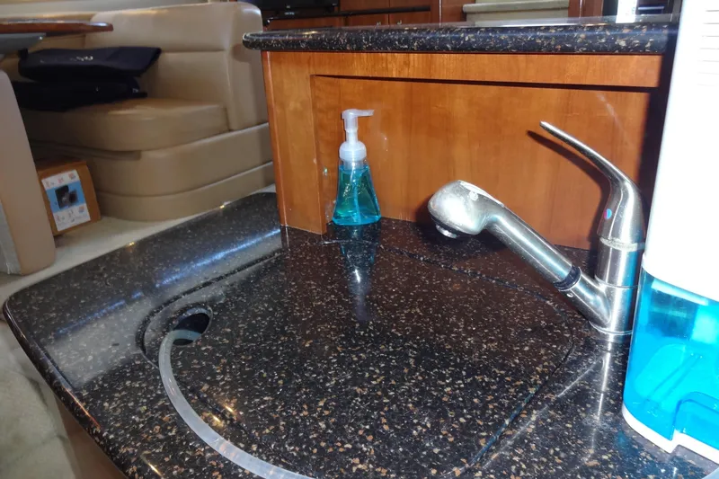 Slide: The Image of Luxury yacht kitchen sink with granite countertop, featuring soap dispenser. Meridian 459, 2007 model. - 120