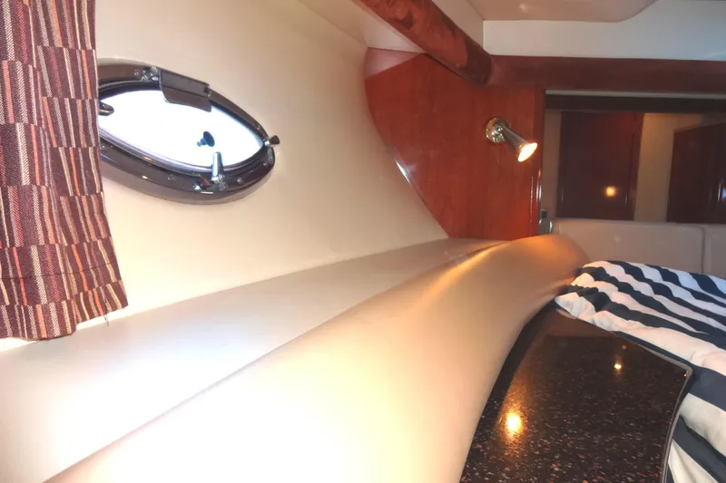 Slide: The Image of Interior cabin of 2007 Meridian 459 yacht with porthole and striped bedding. - 129