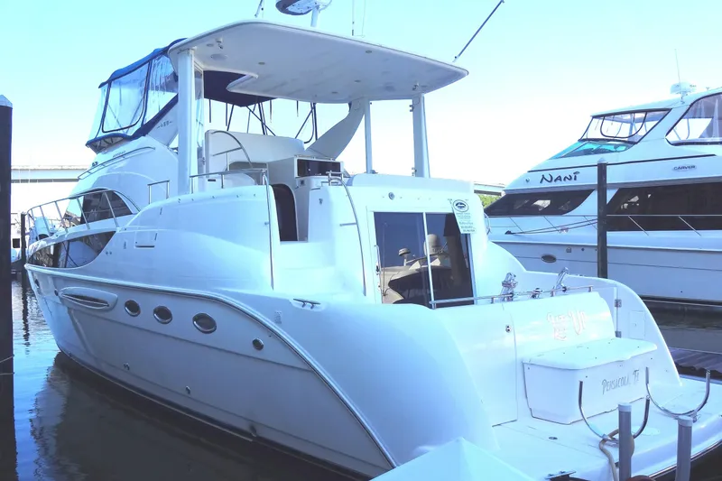 Slide: The Image of 2007 Meridian 459 yacht docked at marina, featuring sleek white design and spacious deck. - 13