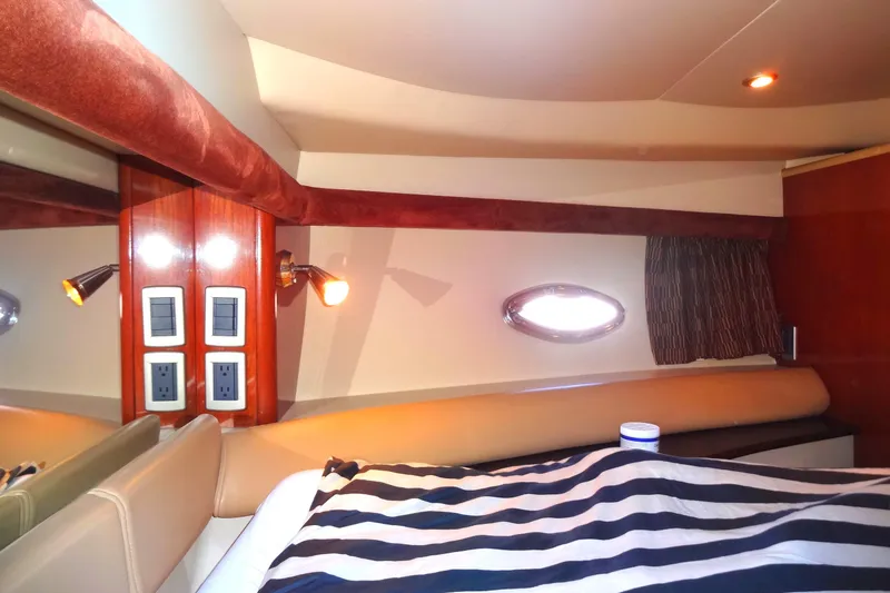 Slide: The Image of Luxurious cabin interior of 2007 Meridian 459 yacht with striped bedding and ambient lighting. - 131