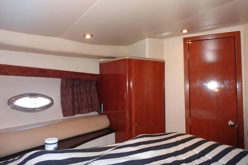 Slide: The Image of Luxurious cabin interior of 2007 Meridian 459 yacht with wood finishes and striped bedding. - 132