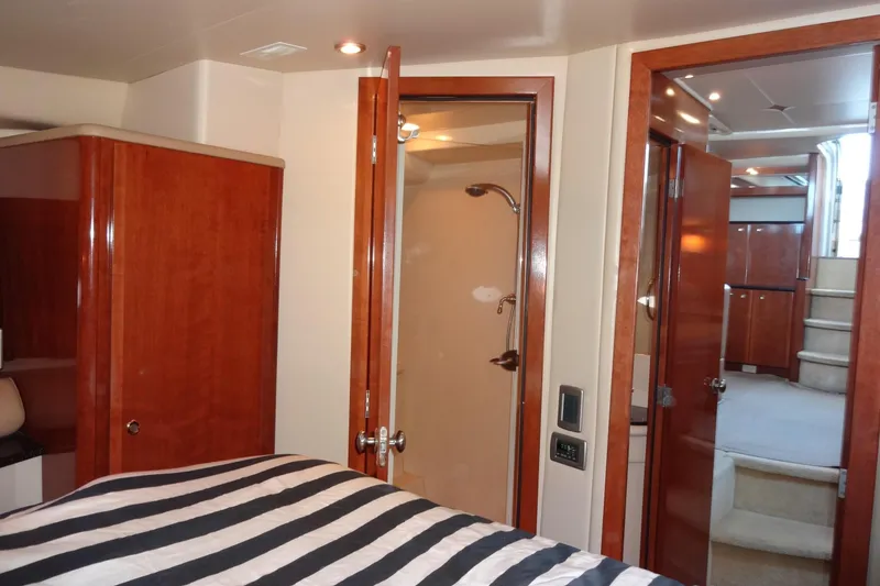 Slide: The Image of Interior of 2007 Meridian 459 yacht with wood finishes and striped bedding. - 133