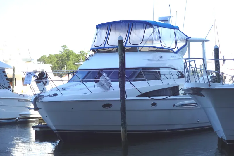 Slide: The Image of 2007 Meridian 459 yacht docked at marina with blue canopy. - 14