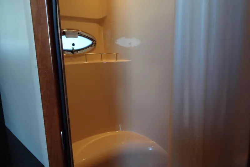 Slide: The Image of Shower area inside a 2007 Meridian 459 yacht, featuring a porthole window. - 142