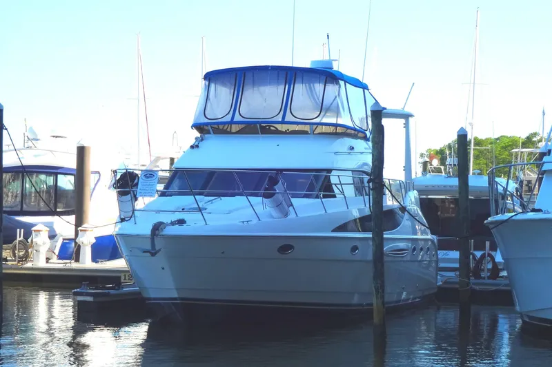 Slide: The Image of 2007 Meridian 459 yacht docked at marina, featuring sleek design and spacious upper deck. - 15