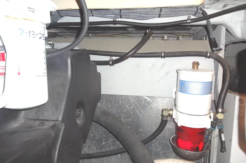 Slide: The Image of Engine compartment of a 2007 Meridian 459 with visible fuel filter and hoses. - 157