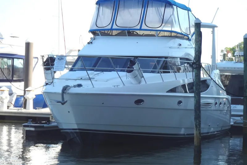 Slide: The Image of 2007 Meridian 459 yacht docked at marina, featuring sleek design and blue canopy. - 16