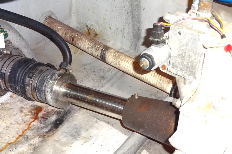 Slide: The Image of Engine compartment of a 2007 Meridian 459 yacht, showing port shaft mechanical components and hoses. - 160