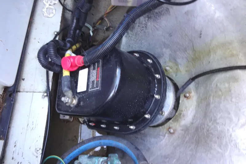 Slide: The Image of Engine compartment of a 2007 Meridian 459 boat, featuring electrical components and wiring for the stern thruster. - 164