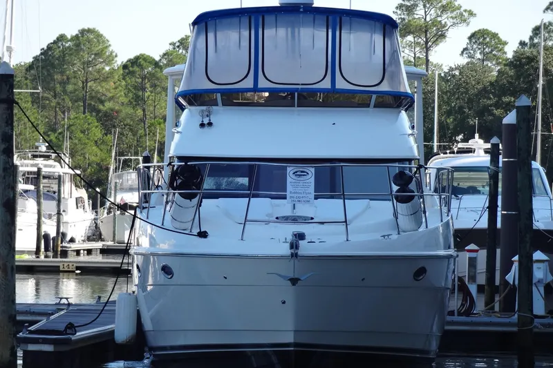 Slide: The Image of 2007 Meridian 459 yacht docked at marina, surrounded by trees and other boats. - 18