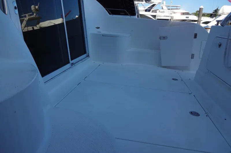 Slide: The Image of 2007 Meridian 459 yacht deck with sliding doors and storage compartments. - 24