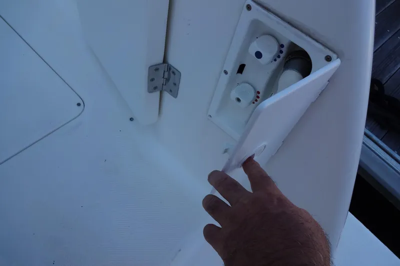 Slide: The Image of Hand opening control panel on 2007 Meridian 459 yacht deck. - 26