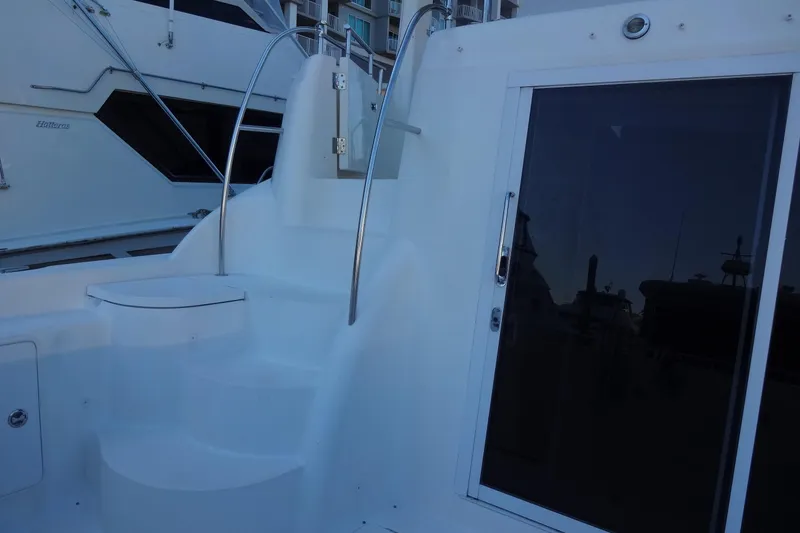 Slide: The Image of 2007 Meridian 459 yacht with sleek white stairs and glass door. - 28