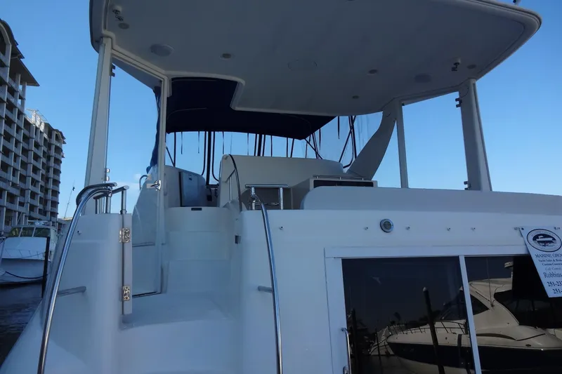 Slide: The Image of 2007 Meridian 459 yacht with upper deck view, docked near waterfront buildings. - 29