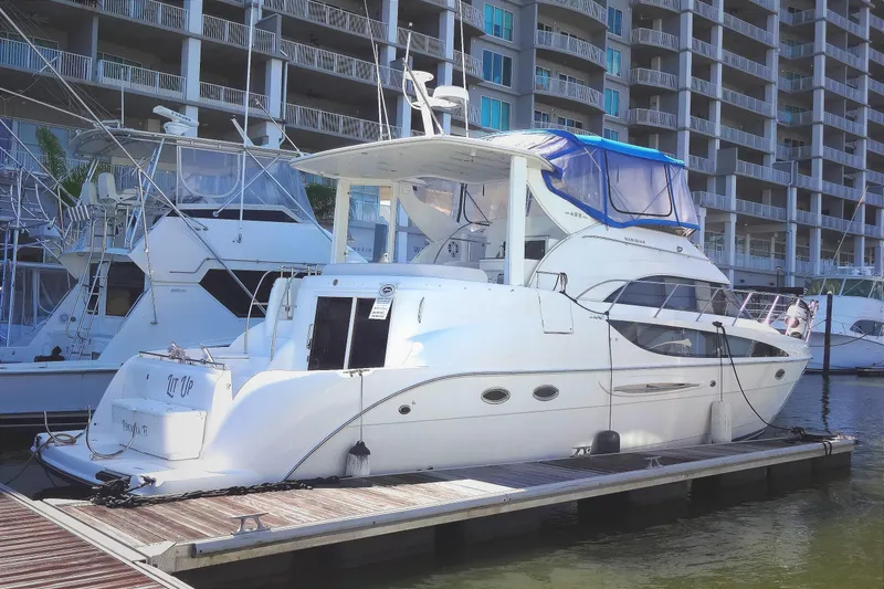 Slide: The Image of 2007 Meridian 459 yacht docked at marina, surrounded by other listings for sale by Robbins Flynn. - 3