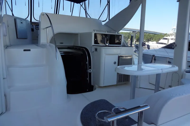 Slide: The Image of 2007 Meridian 459 yacht interior with seating, table, and kitchenette on deck. - 30