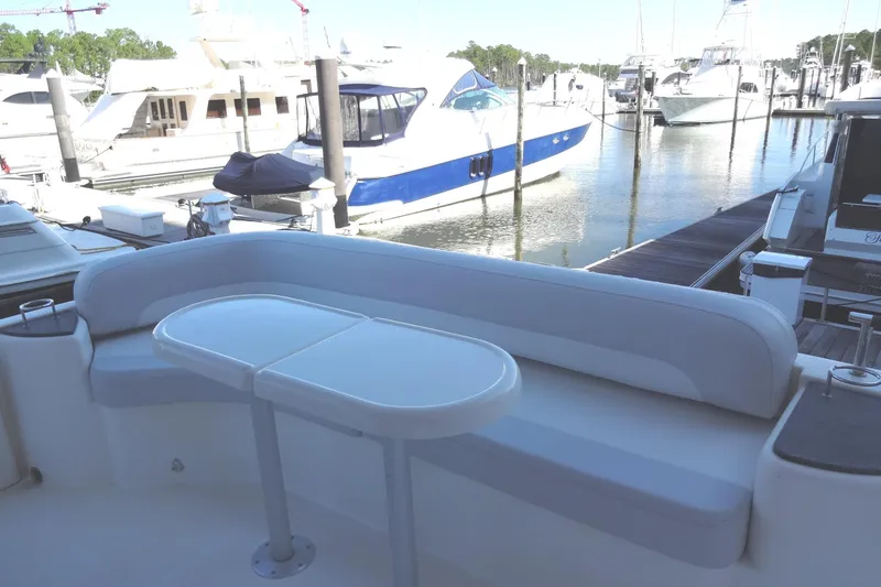 Slide: The Image of Luxury yacht Meridian 459 (2007) docked, featuring a sleek seating area and table. - 34