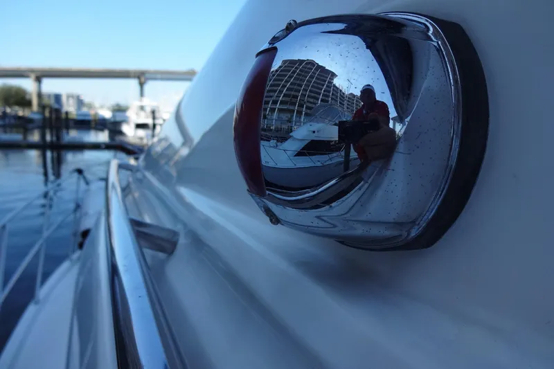 Slide: The Image of Close-up of a 2007 Meridian 459 yacht's chrome detail reflecting marina scene. - 42