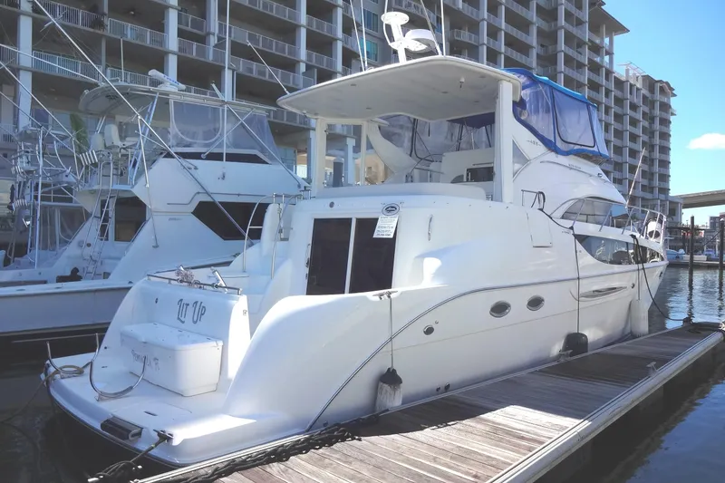 Slide: The Image of 2007 Meridian 459 yacht docked at marina, surrounded by other yachts at the docks for sale by Robbins Flynn. - 5