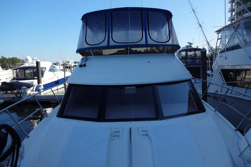 Slide: The Image of 2007 Meridian 459 yacht docked at marina, featuring sleek design and spacious upper deck. - 50