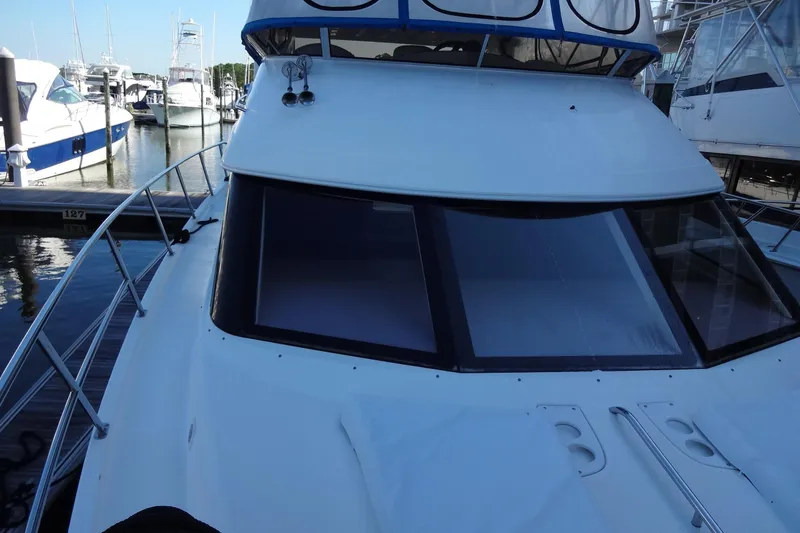 Slide: The Image of 2007 Meridian 459 yacht docked at marina, showcasing sleek design and spacious deck. - 52