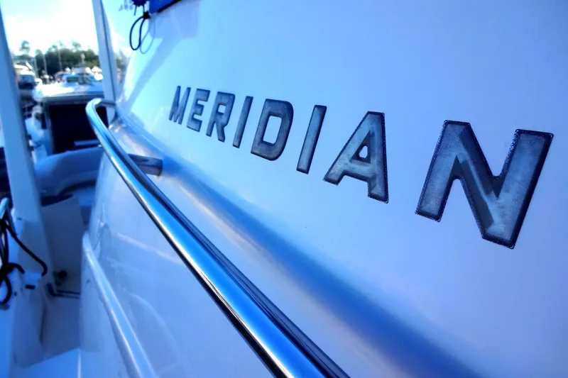 Slide: The Image of 2007 Meridian 459 yacht with chrome railing and logo detail. - 54