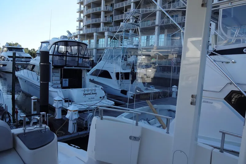 Slide: The Image of Boats docked at a marina, featuring a 2007 Meridian 459 yacht. - 57