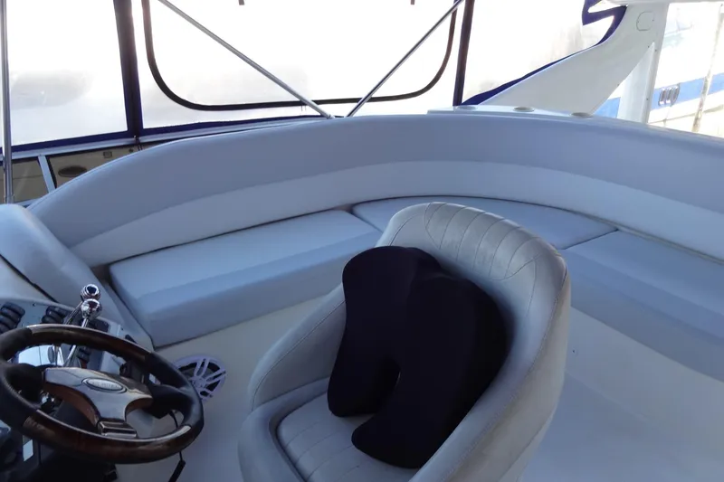Slide: The Image of Interior of a 2007 Meridian 459 yacht, featuring a steering wheel and cushioned seating. - 63