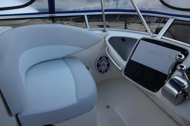 Slide: The Image of 2007 Meridian 459 yacht helm with cushioned seating and navigation controls. - 65