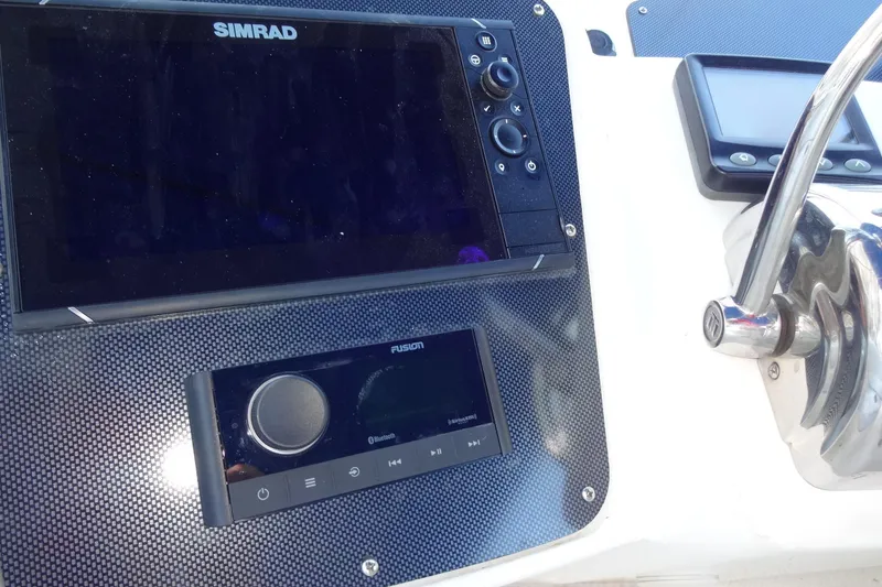 Slide: The Image of Dashboard of 2007 Meridian 459 yacht with Simrad and Fusion controls. - 68