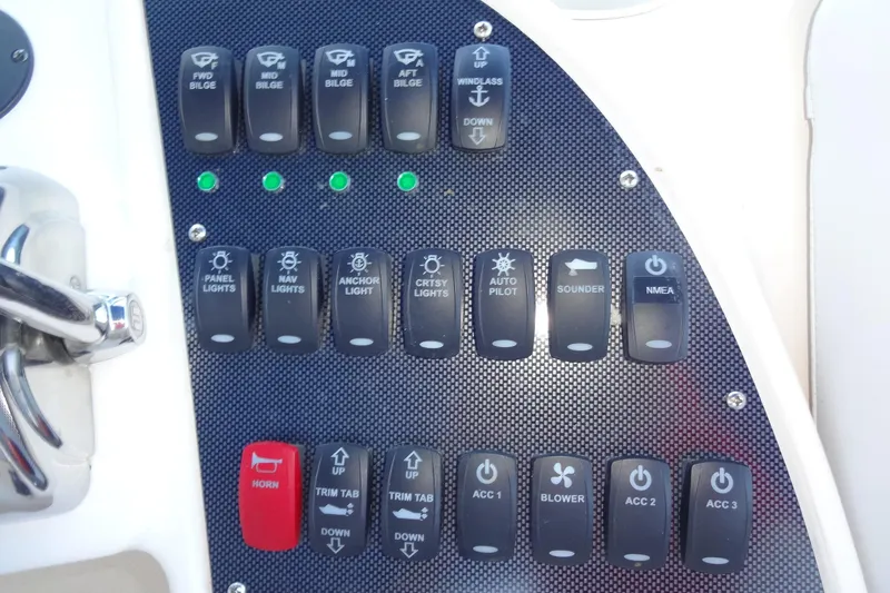 Slide: The Image of Control panel of a 2007 Meridian 459 yacht with labeled switches and buttons. - 72