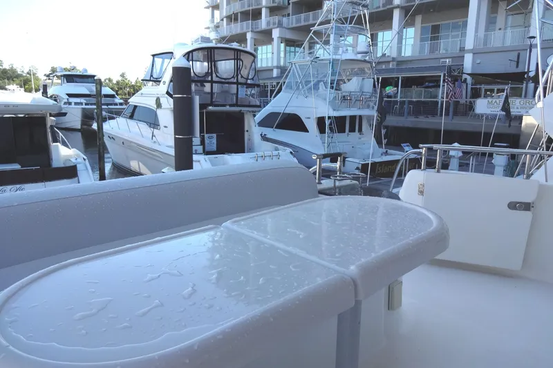 Slide: The Image of 2007 Meridian 459 yacht docked at marina with wet deck table. - 78