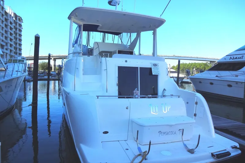 Slide: The Image of 2007 Meridian 459 yacht docked at marina, rear view with clear sky. - 8