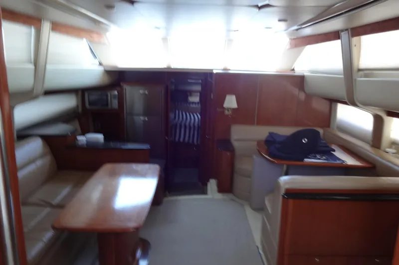 Slide: The Image of Interior of 2007 Meridian 459 yacht with seating, table, and kitchenette. - 81