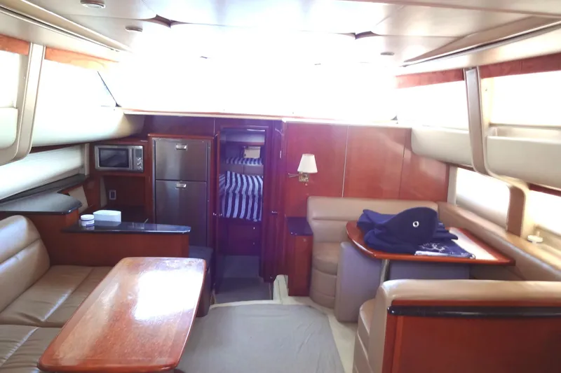 Slide: The Image of Luxurious interior of a 2007 Meridian 459 yacht with seating, table, and kitchenette. - 82