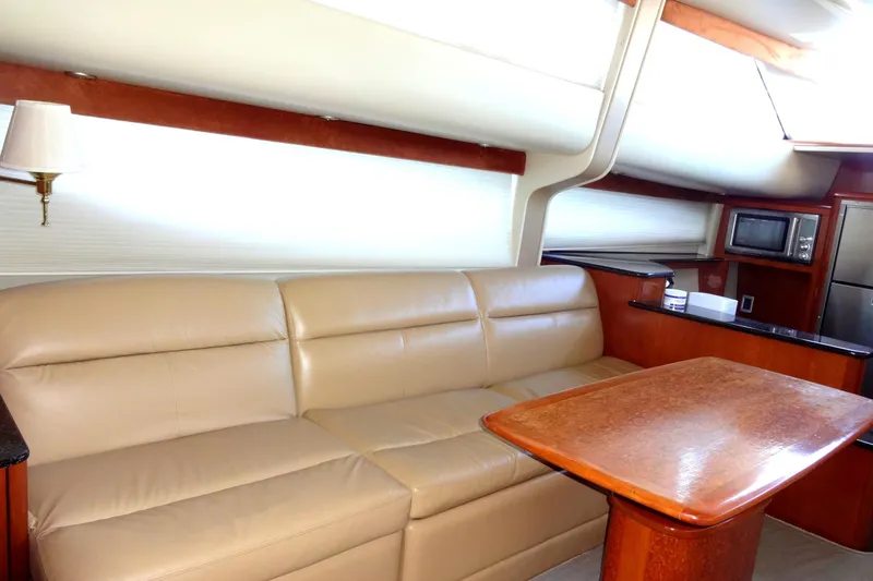 Slide: The Image of Luxurious interior of 2007 Meridian 459 yacht with leather seating and wooden table. - 83