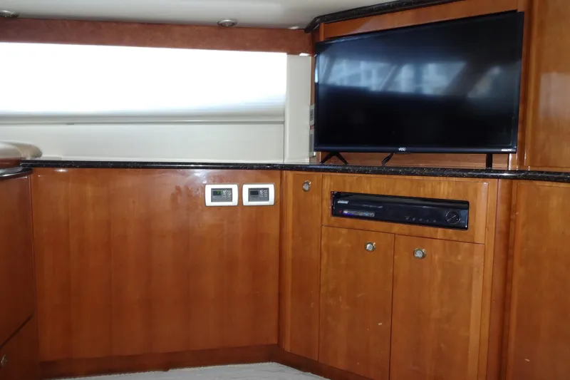 Slide: The Image of Interior of 2007 Meridian 459 yacht with TV and wooden cabinetry. - 84