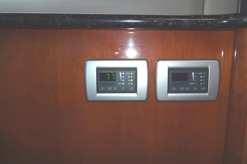 Slide: The Image of Control panels on a 2007 Meridian 459 yacht's wooden interior. - 85