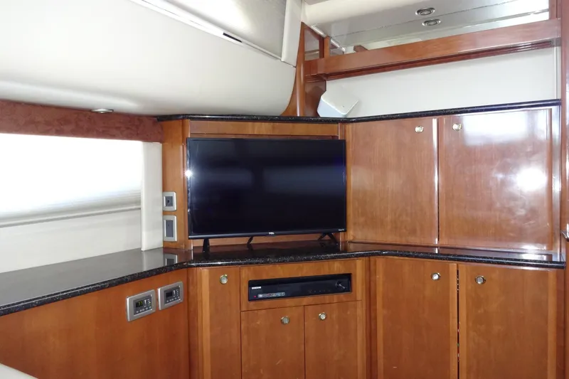 Slide: The Image of Interior of 2007 Meridian 459 yacht with wooden cabinets and a flat-screen TV. - 86